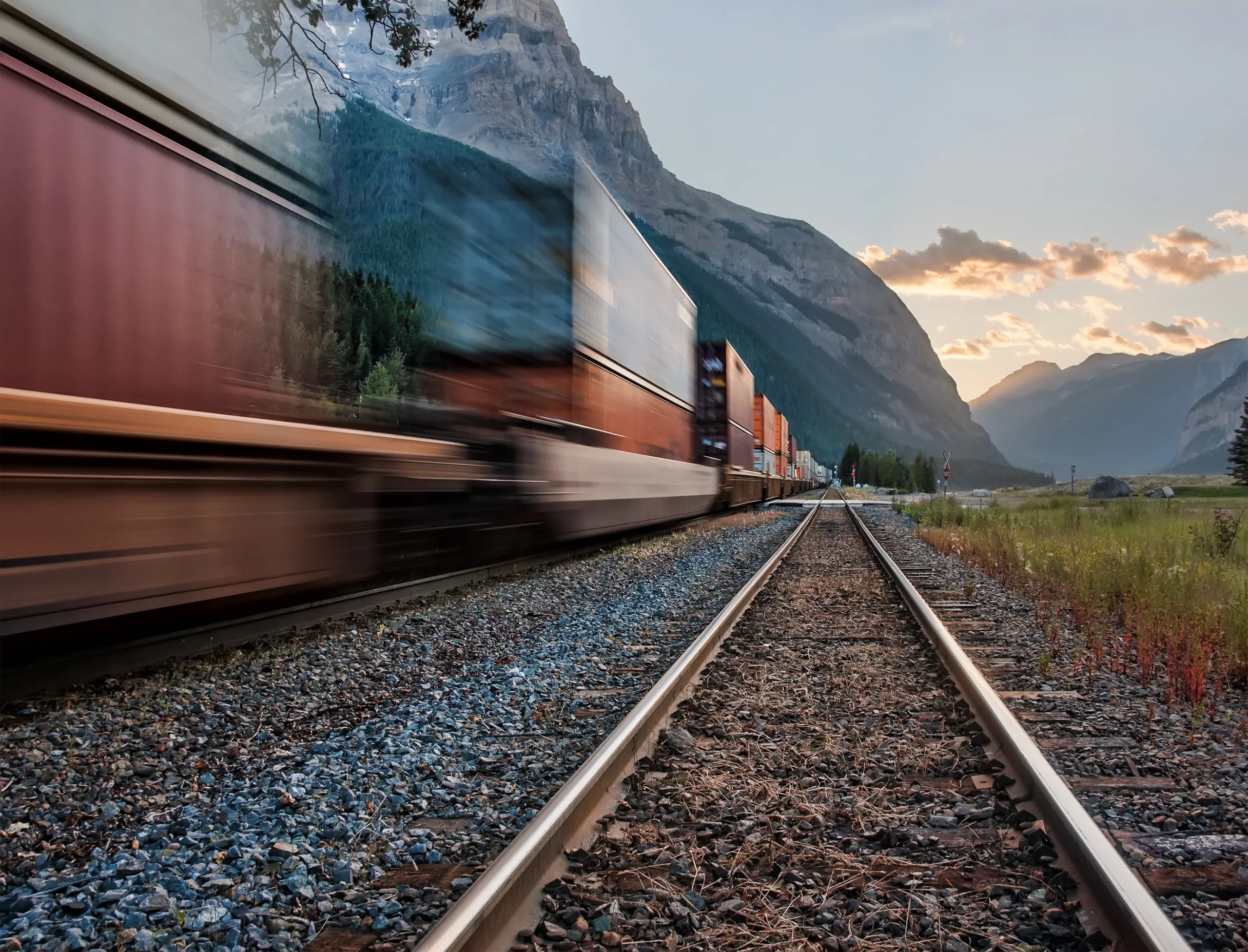 A freight train speeds along the tracks.